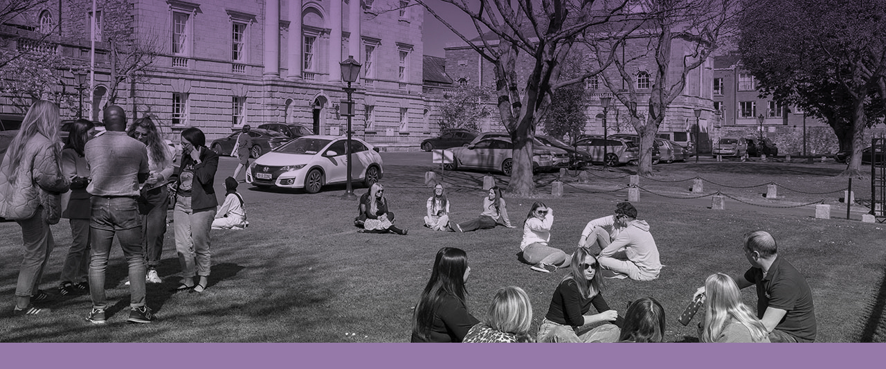 Mixed groups of trainee solicitors talking on the green at Blackhall Place