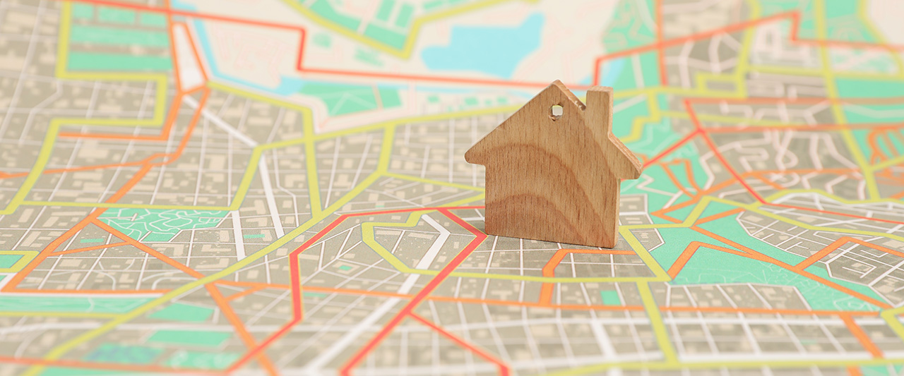 A wooden figure of  property on a stree map