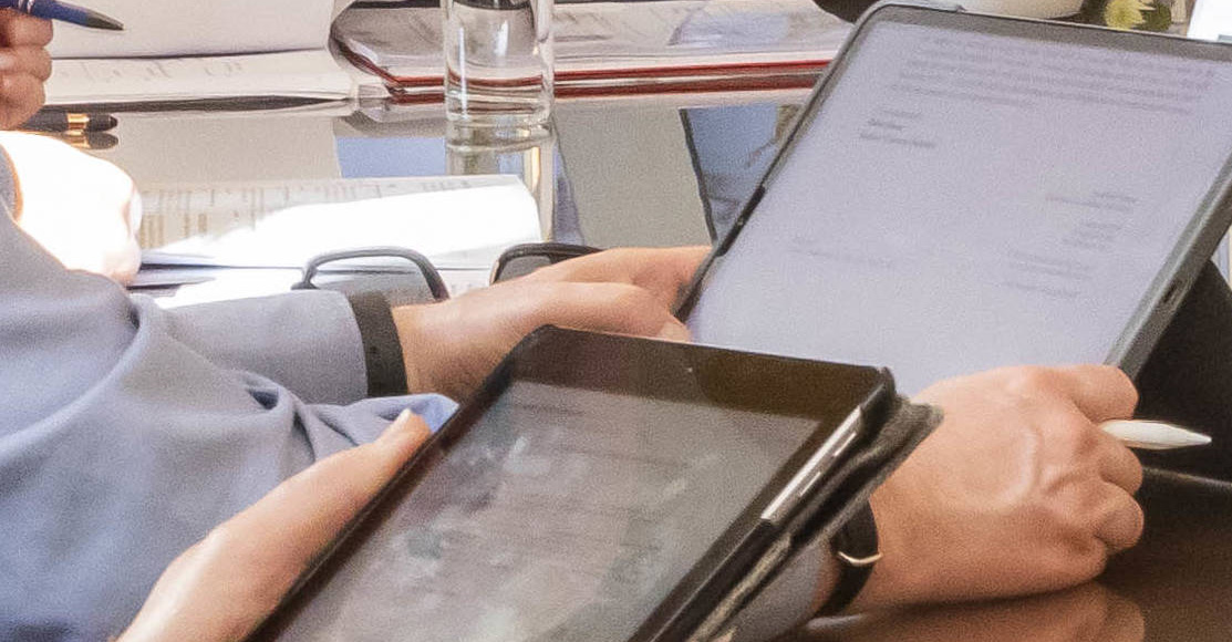 Tablets in use in a legal meeting.